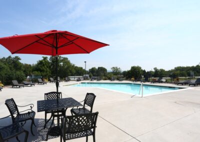 Pool view with pool deck furniture at The Reserve at Manada Hill in Hershey PA. Hershey Apartments for Rent